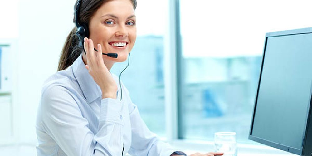 Online consultant Portrait of young operator with headset looking at camera with friendly smile